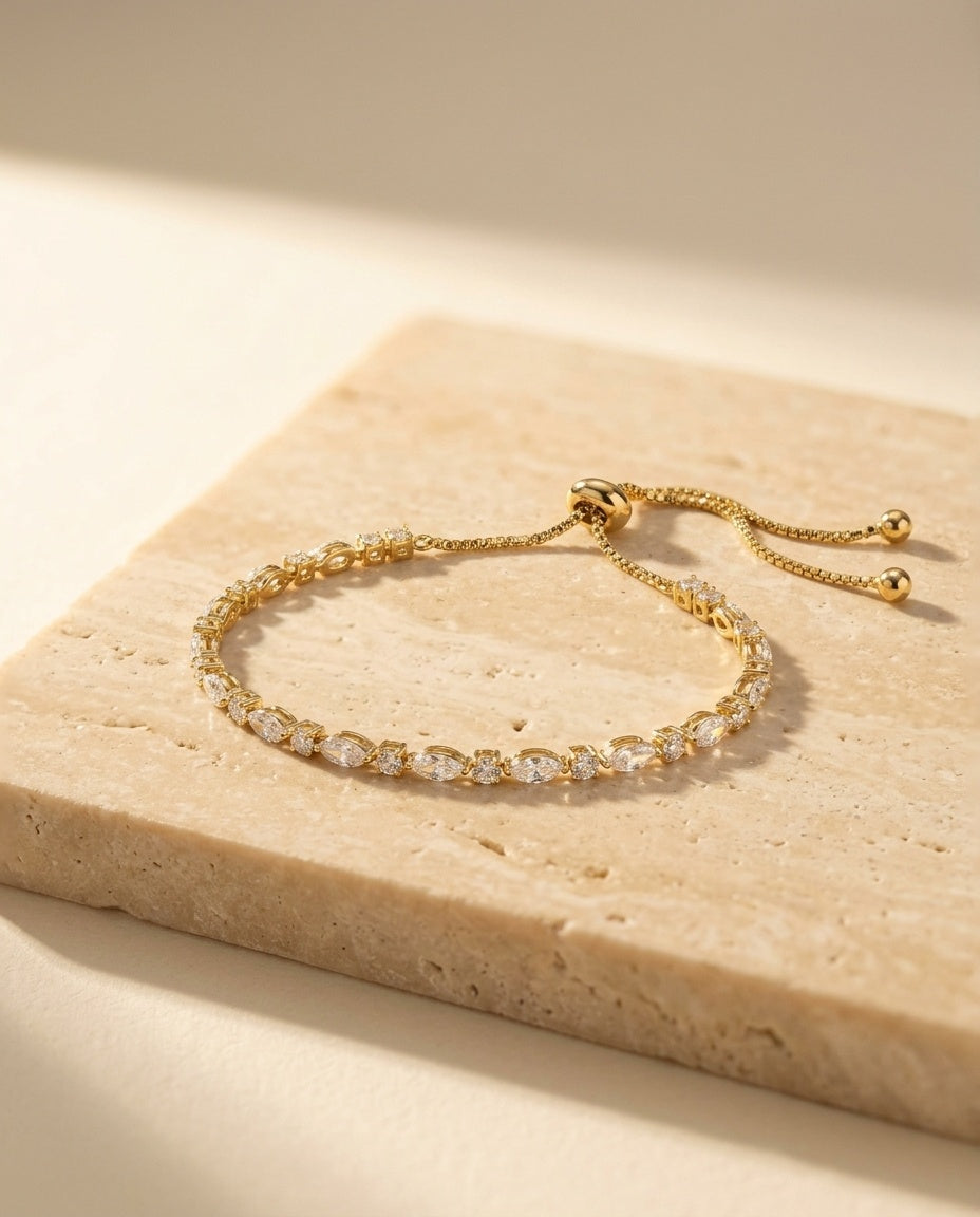 Aria Bracelet on warm travertine stone in golden light