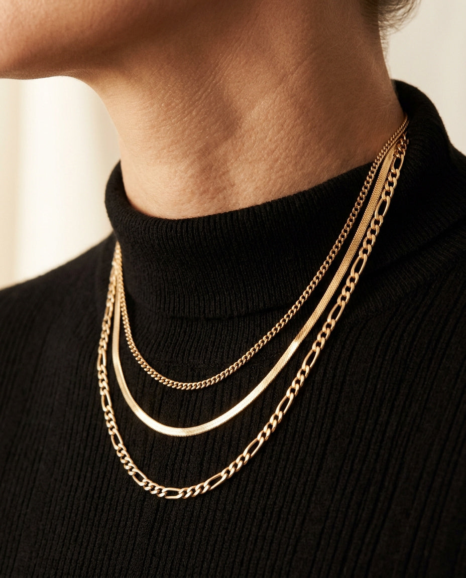 Camille Necklace by ALTUNA worn at the neckline over a black knit, three layered gold chains