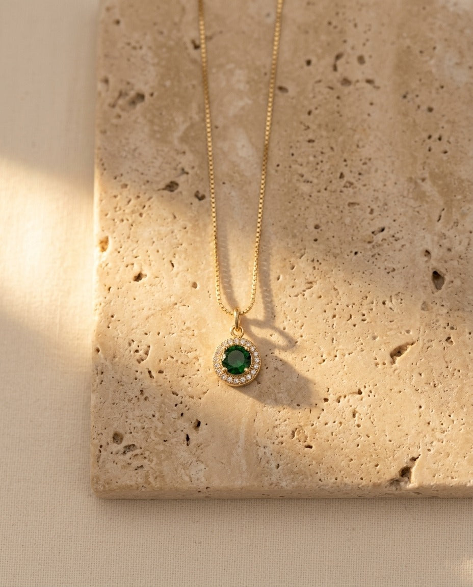 Celina Pendant Necklace in emerald on warm travertine