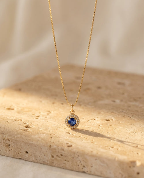 Celina Pendant Necklace in sapphire on warm travertine