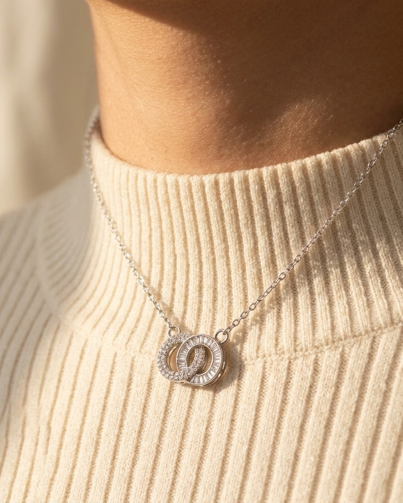 Claire Necklace by ALTUNA worn at the base of the neck over a warm ivory ribbed high-neck knit in golden daylight