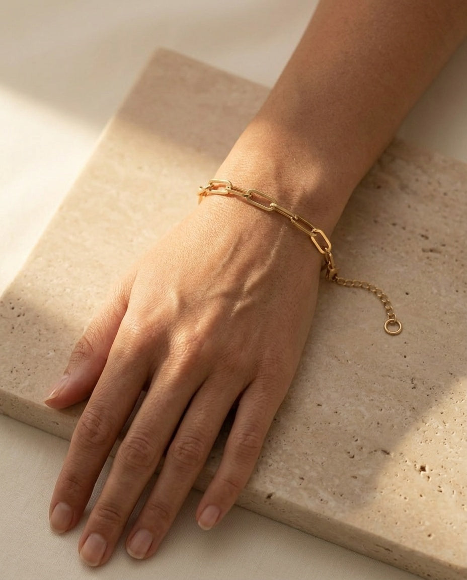 Doré Link Bracelet worn on the wrist, editorial close-up in warm sunlight