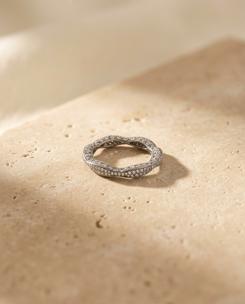 Éclat Ring by ALTUNA resting on warm travertine in soft natural light