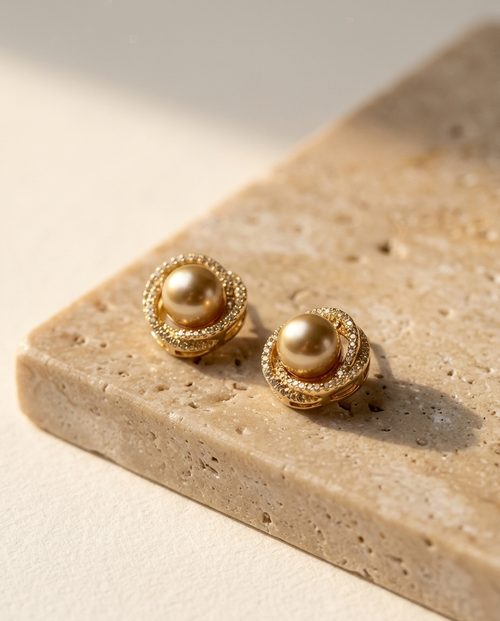 ALTUNA Promise Pearl Halo Studs — editorial product photography on warm beige travertine