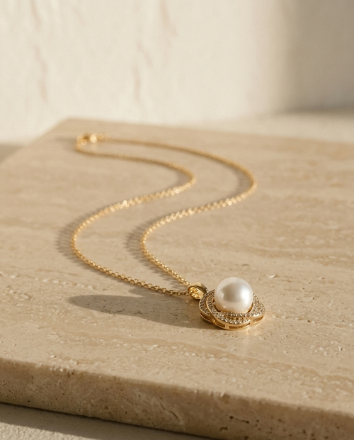ALTUNA Promise Pearl Necklace — editorial product photography on warm beige travertine