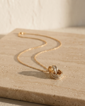 Rêve Doré Necklace on travertine