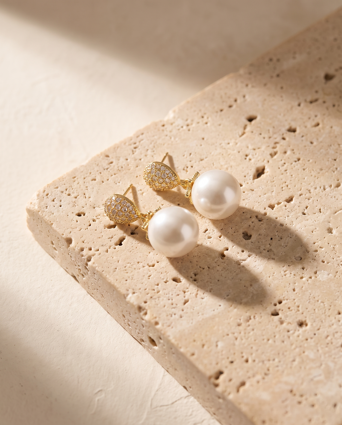 Lilia Pearl Earrings on travertine