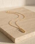 The Linear Link Pendant on travertine