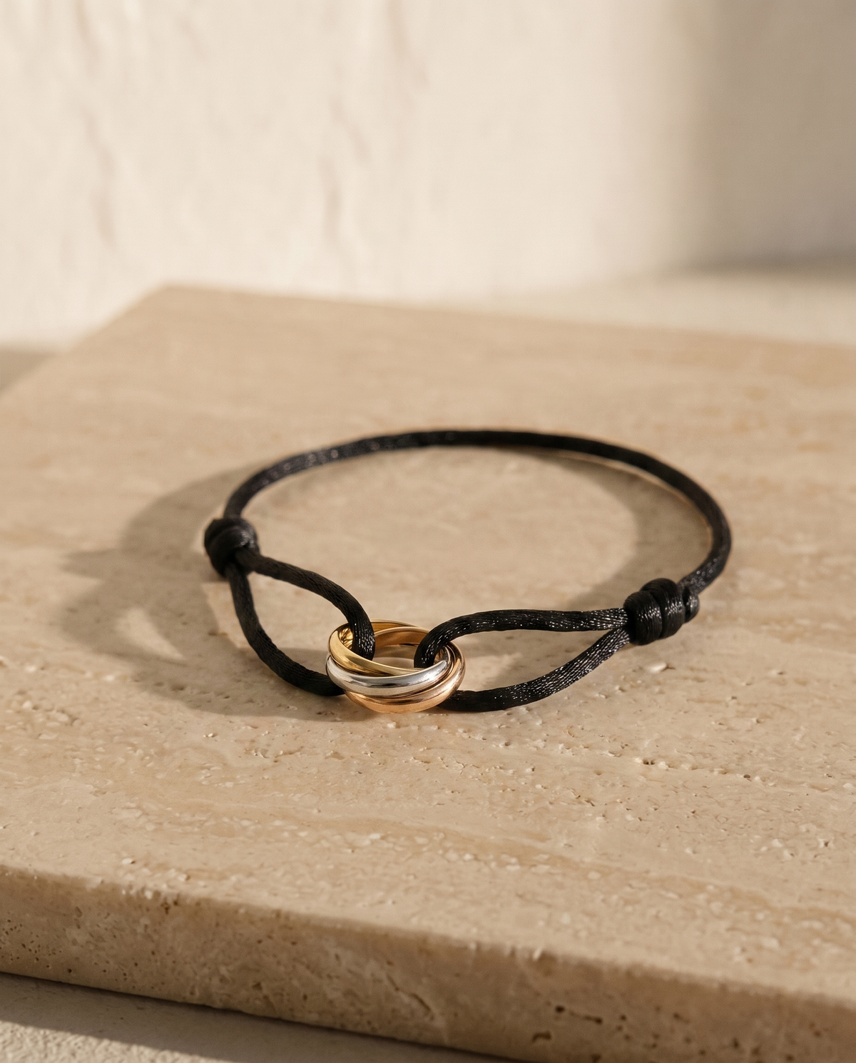 Triune Bracelet in black cord with tri-colour interlocking rings