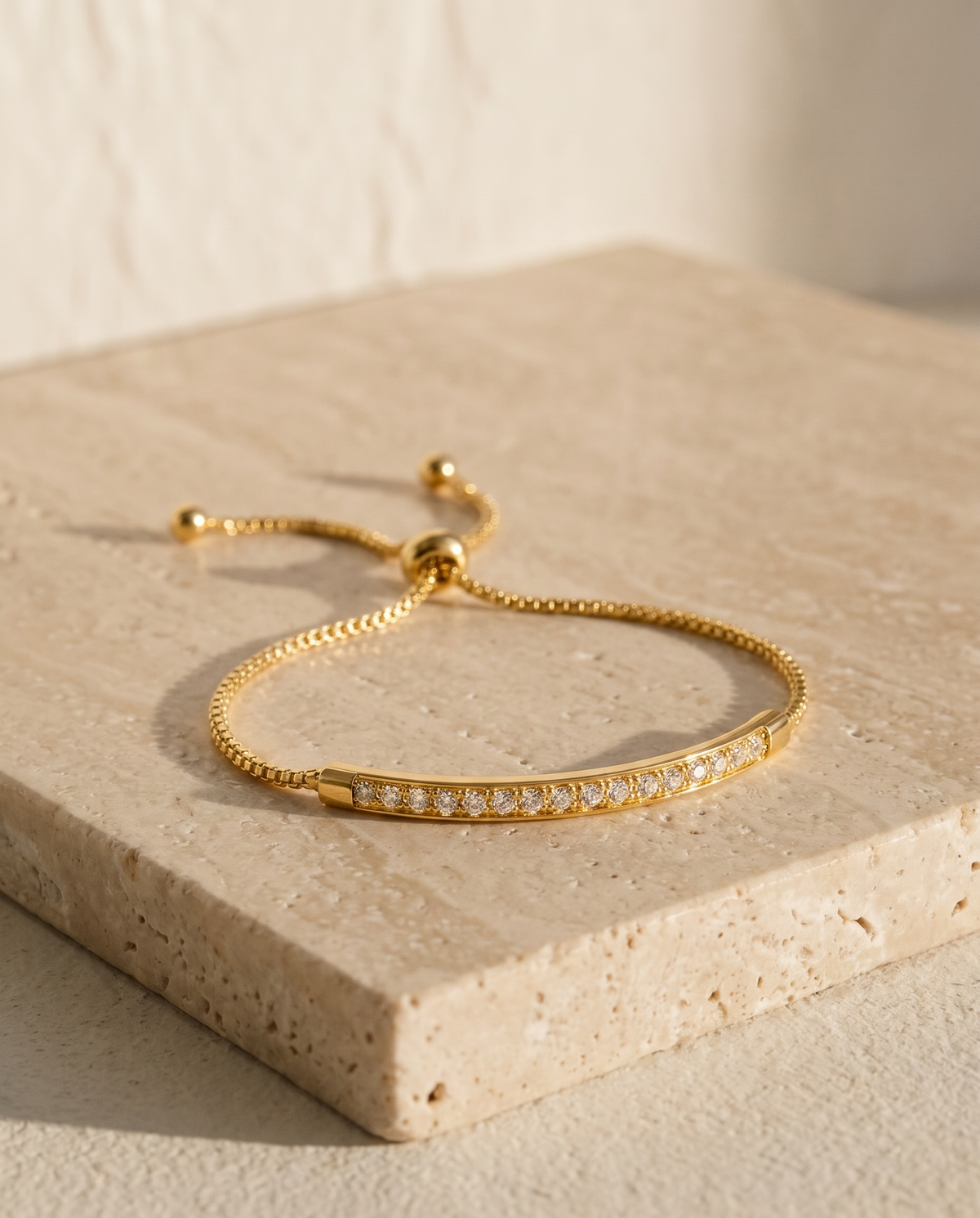 ALTUNA Lumière Bar Bracelet — editorial product photography on warm beige travertine