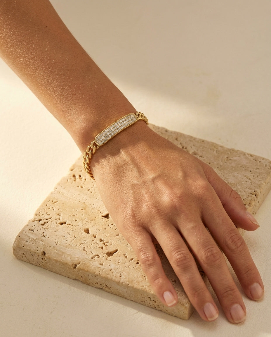 Opéra Bracelet worn on the wrist, pavé bar facing camera, warm natural light