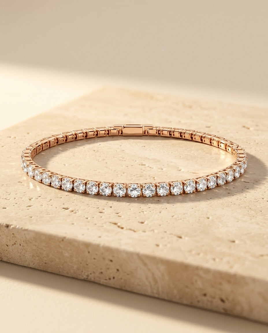 Roselle Bracelet in rose gold resting on warm beige travertine in golden sunlight