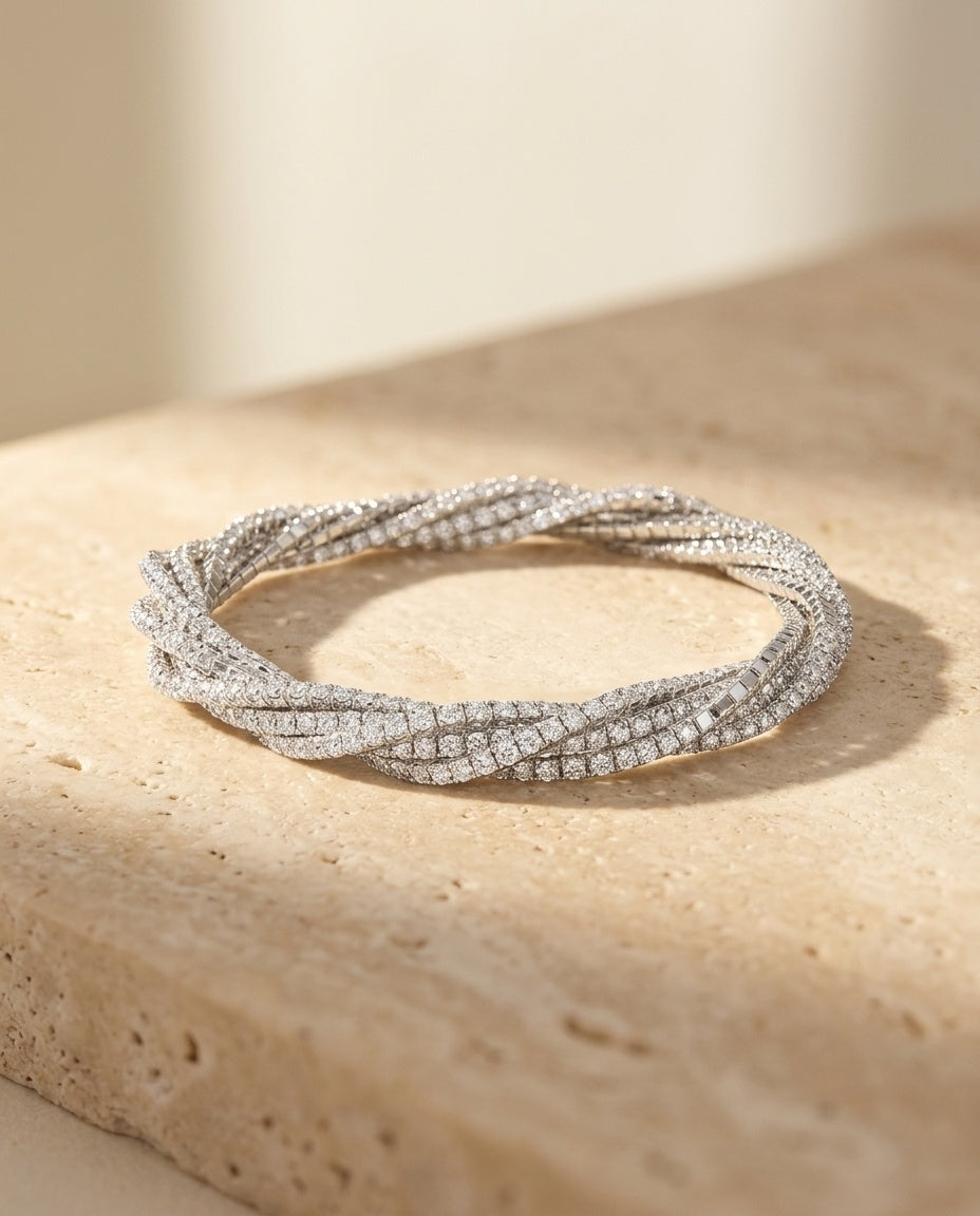 ALTUNA Spirale Bracelet resting on warm travertine in soft golden light