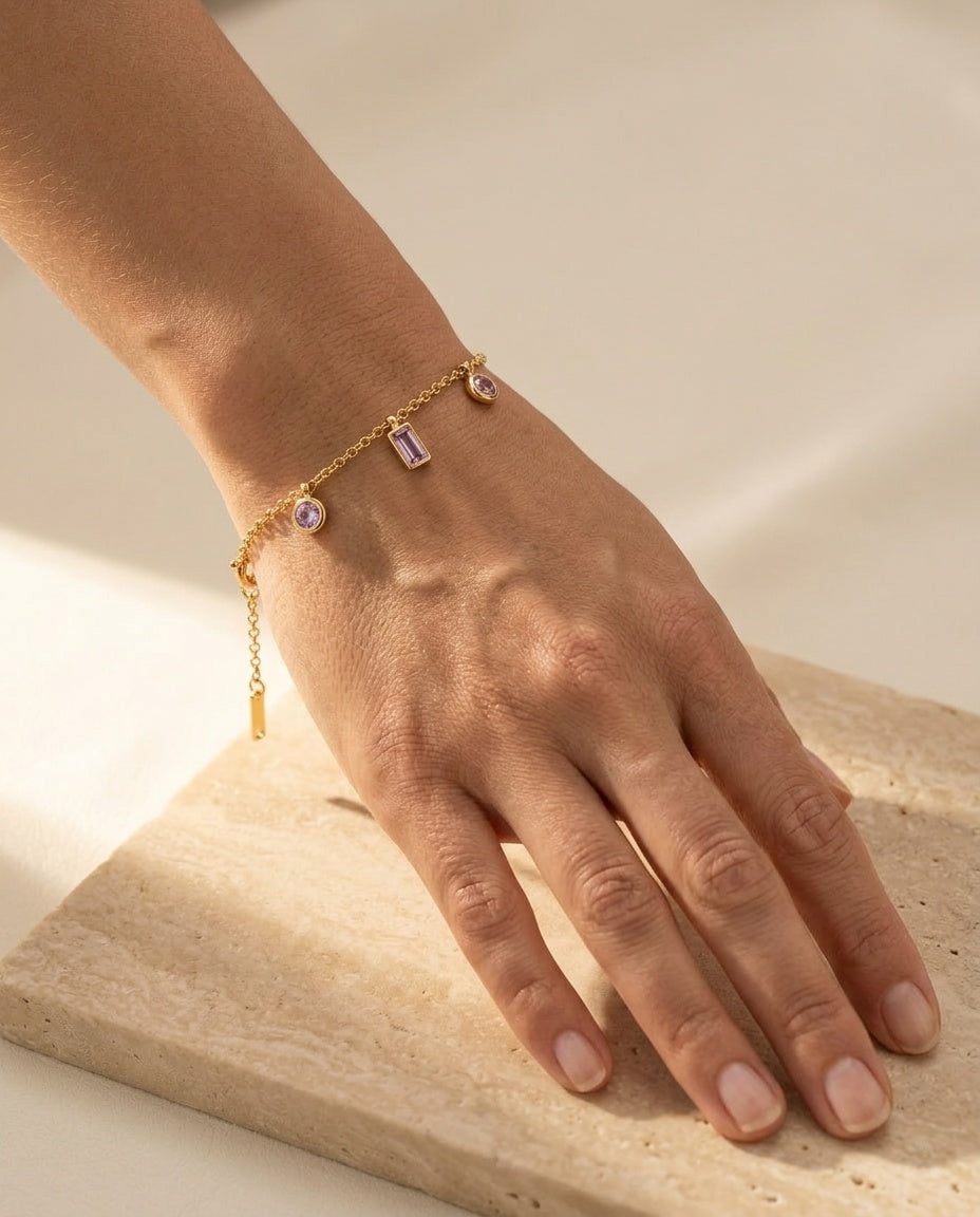Violet Kiss Bracelet worn on the wrist, pale violet amethyst charms draping in warm natural light