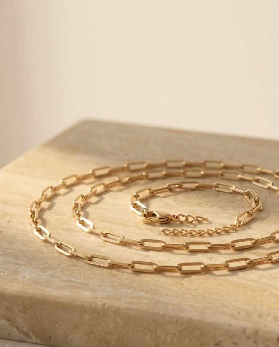 Whisper Chain Necklace - fine yellow-gold paperclip chain detail on travertine